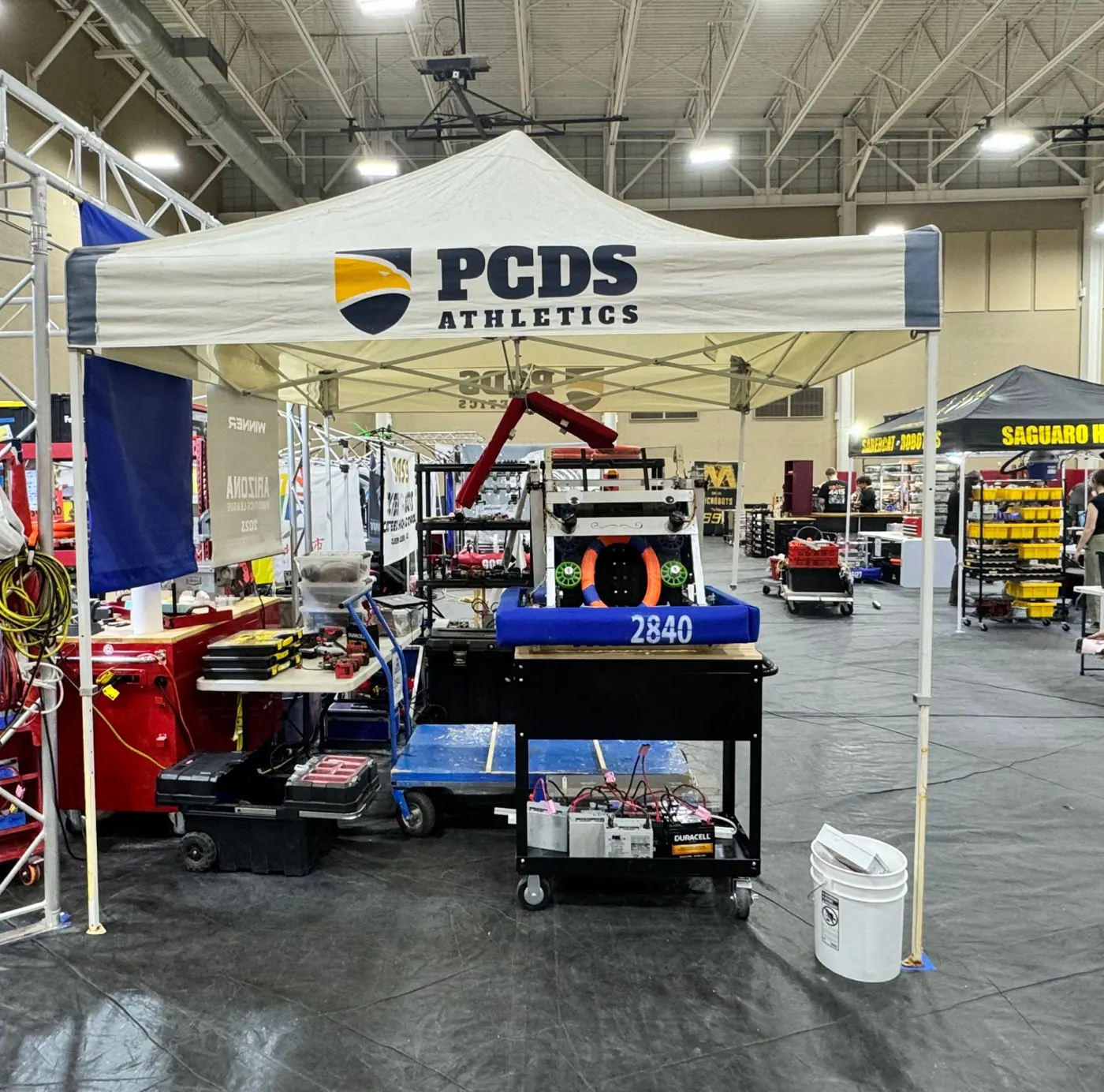 The PCDS Athletics robotics pit at a competition with the robot and tool carts